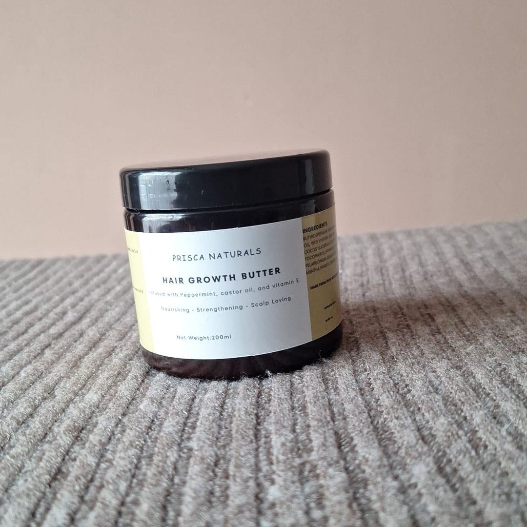 Jar of hair growth butter on a textured surface with a neutral background