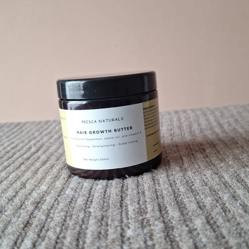 Jar of hair growth butter on a textured surface with a neutral background